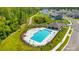 Aerial view of a community pool, walking path, and lush landscaping, providing a serene outdoor environment at 4229 Black Ct # 196, Harrisburg, NC 28075