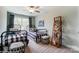 This bedroom with ceiling fan, features two beds with a ladder shelf adding a functional design element at 4229 Black Ct # 196, Harrisburg, NC 28075