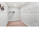 Walk-in closet includes white wire shelving and neutral carpeting at 4229 Black Ct # 196, Harrisburg, NC 28075