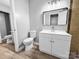 Neutral bathroom featuring single sink vanity, framed mirror, and wood look floors at 4814 Spring Lake Dr # B, Charlotte, NC 28212
