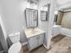 Neutral bathroom featuring single sink vanity, framed mirror, and wood look floors at 4814 Spring Lake Dr # B, Charlotte, NC 28212