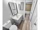 Neutral bathroom featuring single sink vanity, framed mirror, and wood look floors at 4814 Spring Lake Dr # B, Charlotte, NC 28212