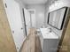 Neutral bathroom featuring single sink vanity, framed mirror, and wood look floors at 4814 Spring Lake Dr # B, Charlotte, NC 28212