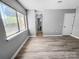 Bright bedroom with hardwood floors, a large window and ample closet space at 4814 Spring Lake Dr # B, Charlotte, NC 28212