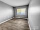 This bedroom features hardwood floors and large window for natural light at 4814 Spring Lake Dr # B, Charlotte, NC 28212