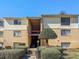Condo exterior features brick facade, stairs, covered entry, and mature landscaping at 4814 Spring Lake Dr # B, Charlotte, NC 28212