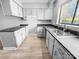 Well-lit kitchen featuring neutral cabinets, countertops, and updated stainless steel faucet and sink at 4814 Spring Lake Dr # B, Charlotte, NC 28212