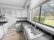 Bright kitchen features neutral cabinets, granite-style countertops, modern sink and faucet at 4814 Spring Lake Dr # B, Charlotte, NC 28212