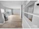 Bright, open living room with fireplace, vinyl floors, shelving and sliding glass doors at 4814 Spring Lake Dr # B, Charlotte, NC 28212