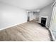 Open living area with fireplace, sliding glass door to the outside and access to the kitchen at 4814 Spring Lake Dr # B, Charlotte, NC 28212