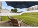 Expansive backyard with lush lawn, privacy fence, and patio seating area at 4917 Spruce Peak Rd, Charlotte, NC 28278