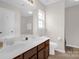 Bathroom featuring dual sinks, a large mirror, and clean lines creating a bright and functional space at 4917 Spruce Peak Rd, Charlotte, NC 28278