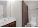 Bathroom featuring a dark wood vanity, neutral-colored walls, a shower curtain, and a toilet at 4917 Spruce Peak Rd, Charlotte, NC 28278