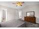 Bedroom featuring carpeted floor, a comfortable bed, and a wooden dresser with a large mirror at 4917 Spruce Peak Rd, Charlotte, NC 28278