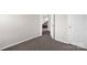 Comfortable bedroom entryway featuring neutral paint and plush carpeting throughout at 4917 Spruce Peak Rd, Charlotte, NC 28278