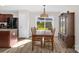 Open-concept dining room featuring hardwood floors, stylish lighting, and convenient access to the backyard at 4917 Spruce Peak Rd, Charlotte, NC 28278