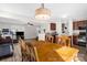 Open dining area featuring hardwood floors, a ceiling fan, an open concept to the kitchen and living room at 4917 Spruce Peak Rd, Charlotte, NC 28278