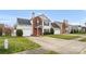 Charming two-story home featuring a red front door, brick accents, green lawn, and attached garage at 4917 Spruce Peak Rd, Charlotte, NC 28278