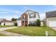 Charming two-story home featuring a red front door, brick accents, green lawn, and attached garage at 4917 Spruce Peak Rd, Charlotte, NC 28278