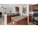 Well-lit kitchen with a sink, oven, microwave, and island with cabinets that provide ample storage space at 4917 Spruce Peak Rd, Charlotte, NC 28278