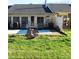 Backyard patio and grassy area with bird bath and landscaping at 504 Camrose Ne Cir, Concord, NC 28025