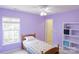 Calm purple bedroom with a twin bed, natural light, and built-in shelves at 513 Buttercup Way, Fort Mill, SC 29715