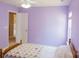 Calming purple bedroom with a quilted bedspread and natural light at 513 Buttercup Way, Fort Mill, SC 29715