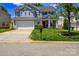 Traditional two-story home featuring a lush front lawn, attached garage, and covered front porch at 513 Buttercup Way, Fort Mill, SC 29715