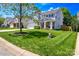 Charming two-story home with a well-manicured lawn, lush landscaping, and inviting front porch at 513 Buttercup Way, Fort Mill, SC 29715