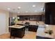 Well-equipped kitchen with dark wood cabinetry, stainless steel appliances, and tiled floor at 513 Buttercup Way, Fort Mill, SC 29715