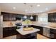 Charming kitchen with dark cabinets, stainless steel appliances, and a center island at 513 Buttercup Way, Fort Mill, SC 29715