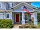 Inviting front porch with seating area, and a vibrant red door at 513 Buttercup Way, Fort Mill, SC 29715