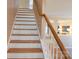 Interior staircase with wood railing and white risers at 513 Buttercup Way, Fort Mill, SC 29715