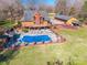 Aerial view showcasing a pool, backyard, and the home's exterior nestled in a wooded landscape at 529 Langley Rd, Lancaster, SC 29720