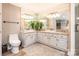 Bathroom features a granite countertop, white cabinets and a large mirror, providing an elegant and functional space at 529 Langley Rd, Lancaster, SC 29720