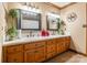 Double vanity in the bathroom with tile countertops, framed mirrors, and wood cabinets at 529 Langley Rd, Lancaster, SC 29720