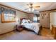 Bedroom features a wood-framed bed with plush bedding, a ceiling fan, and a cozy, inviting atmosphere at 529 Langley Rd, Lancaster, SC 29720