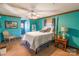 Bedroom showcases turquoise walls, carpeting, a four-poster bed and natural light from multiple windows at 529 Langley Rd, Lancaster, SC 29720