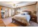 Bedroom featuring a wooden bed frame, wood trim, side tables with lamps and a ceiling fan at 529 Langley Rd, Lancaster, SC 29720