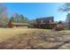Sprawling home featuring an expansive front lawn, large porch, outbuilding, and ample parking at 529 Langley Rd, Lancaster, SC 29720