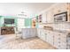 Eat-in kitchen with white cabinets, granite countertops, subway tile backsplash and an adjacent living area at 529 Langley Rd, Lancaster, SC 29720