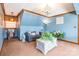 Cozy living room with blue walls, chandelier lighting, neutral carpet and white wooden trim at 529 Langley Rd, Lancaster, SC 29720