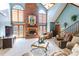 Bright and airy living room features a soaring brick fireplace, plush seating, and plenty of light at 529 Langley Rd, Lancaster, SC 29720