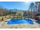 Beautiful backyard pool with a diving board and slide overlooking the pond and a blooming tree at 529 Langley Rd, Lancaster, SC 29720