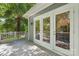 Inviting back porch that leads to an outdoor living space with a gray deck, white railing, and a set of double doors at 545 Dilworth Mews Ct, Charlotte, NC 28203