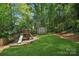 Lush backyard featuring playground, shed and well-manicured lawn at 545 Dilworth Mews Ct, Charlotte, NC 28203