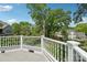 Inviting deck with white railing overlooking a beautifully landscaped backyard with mature trees at 545 Dilworth Mews Ct, Charlotte, NC 28203