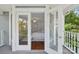 Balcony view through open French doors to bright main bedroom at 545 Dilworth Mews Ct, Charlotte, NC 28203