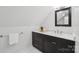 Bathroom with a modern vanity, granite countertop, and a decorative framed mirror at 545 Dilworth Mews Ct, Charlotte, NC 28203