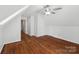 Attic bedroom featuring hardwood floors, ceiling fan, and dormer windows offering natural light at 545 Dilworth Mews Ct, Charlotte, NC 28203